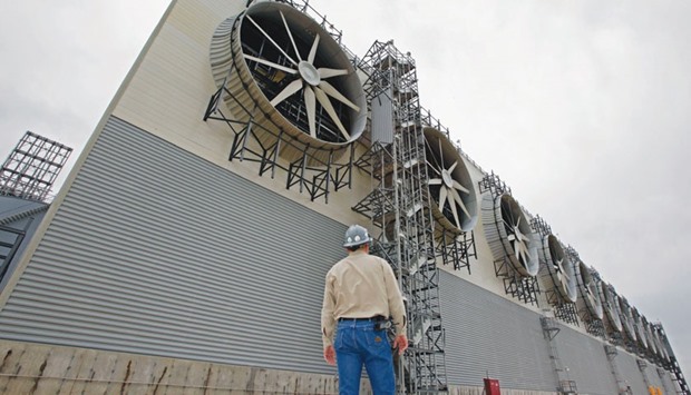 A supervisor looks up at a bank of fans used in the heating process at the Freeport LNG facility in Quintana, Texas, US. Five US liquefaction projects are now being built and they could have a combined capacity to ship 7.76bn cubic feet of LNG a day by 2019, according to an analysis by Bloomberg New Energy Finance. Thatu2019s enough to put the US in the company of Russia and Qatar, the worldu2019s largest gas exporters.