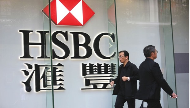 Pedestrians walk past a sign of HSBC in Hong Kong. As part of its expansion plan, HSBC is looking to set up a joint venture in China with a majority equity stake.
