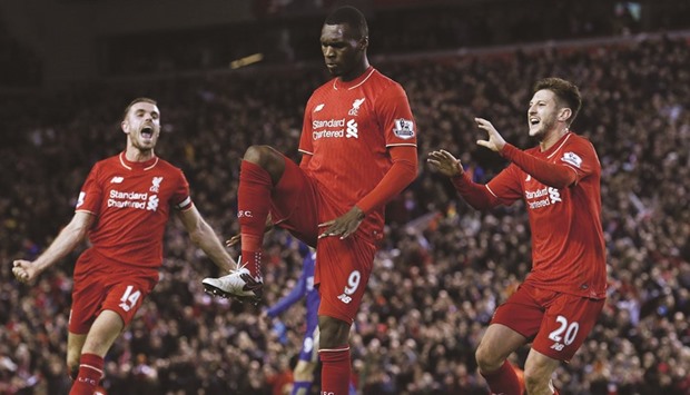 Liverpool striker Christian Benteke (C) celebrates with teammates after scoring the opening goal during the EPL match against Leicester City at the Anfield stadium.