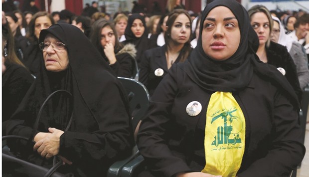 Zeinab Berjawi, the wife of Hezbollah militant leader Samir Qantar, sits next to the mother of Hezbollahu2019s late military leader Imad Moughniyah during a commemoration service marking one week since the killing of Qantar, in Beirutu2019s southern suburbs, yesterday.