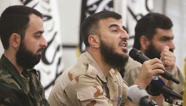 Zahran Alloush (centre), commander of Jaish al-Islam, talks during a conference in the town of Douma, eastern Ghouta in Damascus, on August 27, 2014. Alloushu2019s killing has eliminated a key bulwark against the IS militants.