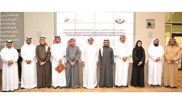 HE the Minister of Environment Ahmed bin Amer al-Humaidi and QU president Dr Hassan al-Derham with other officials at the agreement signing ceremony.