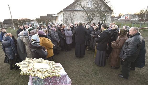 Believers of the Russian Church hold a religious service near the church in Ptycha. Ptycha, a village of some 1,000 residents is seeing tensions around a parish belonging to the Moscow Church as the Kiev patriarchy wants it to be handed under its control.