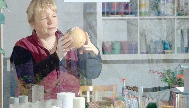AT WORK: Katrin Fahle, 41, checks a spherical candle in her workshop in Goednitz, Germany.