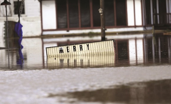 A sign sits underwater located in the downtown area of Elba, Alabama. Alabama has been hit with storms and heavy rain since Wednesday.