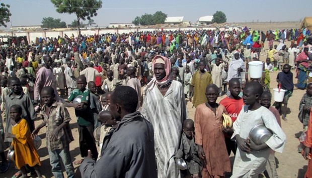 Internally displaced people gather during a visit from the Borno state governor at a camp in Borno, Nigeria.