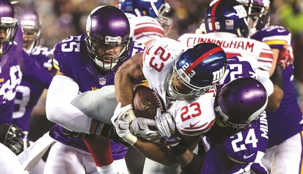 New York Giants running back Rashad Jennings (No 23) is tackled by Minnesota Vikings cornerback Captain Munnerlyn (No 24) and linebacker Anthony Barr (No 55) during the second quarter at TCF Bank Stadium. PICTURE: USA TODAY Sports