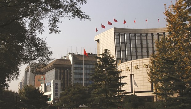 The Peopleu2019s Bank of China headquarters (right) is seen in the financial district of Beijing. The monetary policy committee, an advisory body led by the PBoC Governor Zhou Xiaochuan, reiterated that the central bank will use monetary policy tools flexibly.
