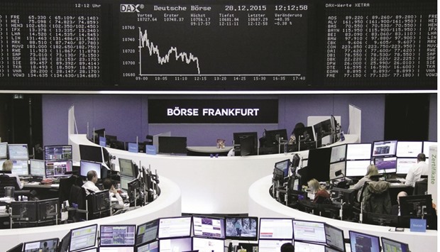 Traders work at the Frankfurt Stock Exchange. The DAX was off 0.7% at the close yesterday.