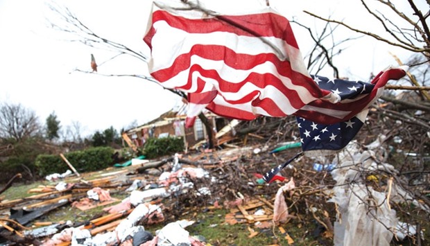 An American flag placed by first responders is seen on Sunday in the aftermath of a tornado in Rowlett, Texas. At least 11 people lost their lives as tornadoes tore through Texas, authorities said, as they searched home to home for possible more victims of the freak storms lashing the southern United States.
