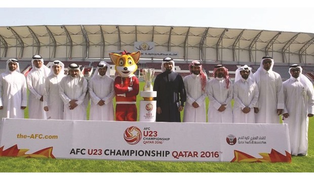 Officials pose during the launch of the official mascot Najim.