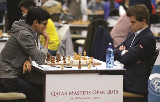 Anish Giri (left) of the Netherlands contemplates a move during his game against Magnus Carlsen of Norway in the Qatar Masters Open at Aspire Zone. The game ended in a draw. PICTURES: Jayaram