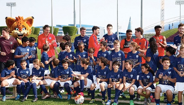 PSG players pose with the lucky kids who got to train with the likes of star striker Zlatan Ibrahimovic and coach Laurent Blanc.