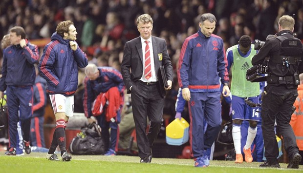 Manchester Unitedu2019s Dutch manager Louis van Gaal (C) leaves the pitch after the final whistle of the English Premier League match between Manchester United and Chelsea at Old Trafford in Manchester on Monday.