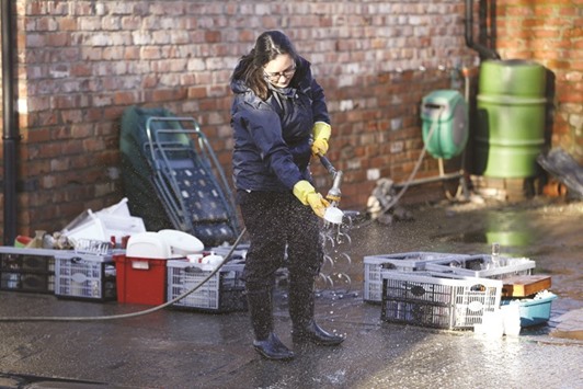 A resident cleans up after flood waters receded on Huntington Road in York yesterday.