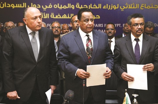 Foreign Ministers Sameh Shoukry of Egypt (left), Ibrahim Ghandour of Sudan (centre) and Ethiopiau2019s Tedros Adhanom pose for a group picture after reaching an agreement following another round of talks on the Grand Ethiopian Renaissance Dam (GERD) project that has strained ties between Cairo and Addis Ababa, in Khartoum yesterday.