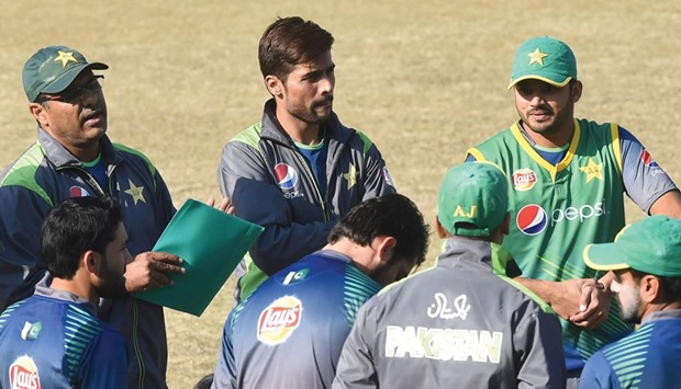 Pakistani coach Waqar Younis (left) speaks to players as Mohammad Amir (centre) and Azhar Ali listen during a practice session in Lahore. (AFP)