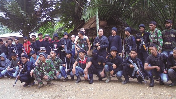 Head of Indonesiau2019s State Intelligent Agency Sutiyoso (fifth right) and leader of separatists Nurdin (sixth right) pose with members of a rebel group in Ladang Baro, East Aceh  yesterday.