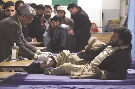 A man, who sustained injuries in a suicide attack at a government office, receives first aid at the Lady Reading Hospital in Peshawar yesterday.
