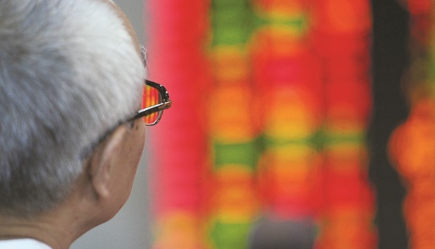 An investor watches his stocks at a securities exchange in Shanghai. That piggy-back strategy, while completely legal, is magnifying the challenge for Chinese policy makers as they try to improve the international image of a $7.2tn stock market where valuations often appear detached from economic fundamentals. Global money managers cut their holdings of mainland shares by about 5% in the first nine months of 2015, even after authorities made it easier than ever to bring money into the country.