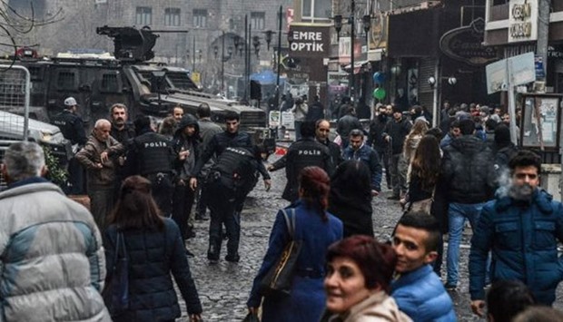 Turkish police conduct security checks in the mainly Kurdish city of Diyarbakir. Police in Ankara have arrested two suspected Islamic State militants.