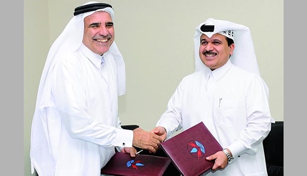 QEWC managing director Fahad bin Hamad al-Mohannadi (left) shaking hands with CEO of Nebras Power Khalid M Jolo at the signing ceremony yesterday. PICTURE: Shaji Kayamkulam