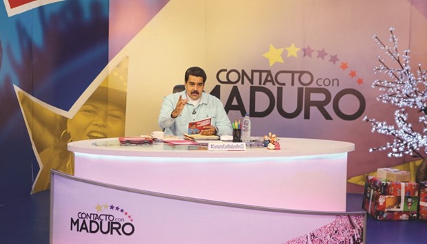 President Maduro sits at a desk during his weekly broadcast u201cen contacto con Madurou201d (In contact with Maduro) at the Miraflores Palace in Caracas.