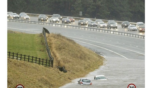 Cars submerged in floodwaters are seen on the M74 near Abington in south Lanarkshire, Scotland.