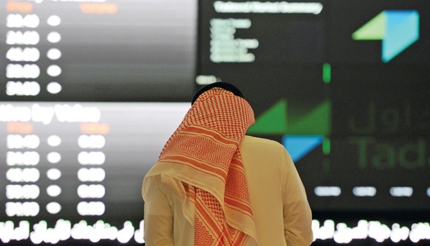 A Saudi investor monitors share prices at the Saudi Stock Exchange (Tadawul). Saudi Arabia, Dubai, Egypt and other regional bourses were caught in an emerging market downturn last year and the Gulf was hit by shrinking oil revenues, while a severe foreign exchange shortage plagued Egypt.