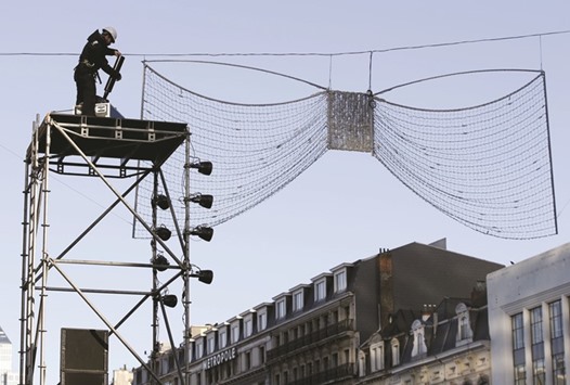 A worker dismantles equipment yesterday that would have been used to celebrate New Year in central Brussels. Authorities in the Belgian capital Brussels on Wednesday called off the cityu2019s traditional New Yearu2019s Eve fireworks display, citing fears of a militant attack.