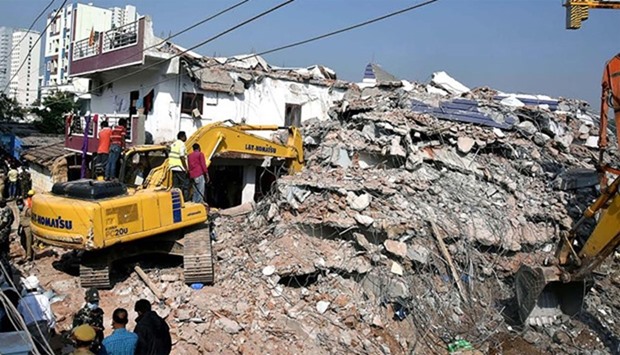 Indian rescue workers dig through the rubble of a collapsed building in Hyderabad