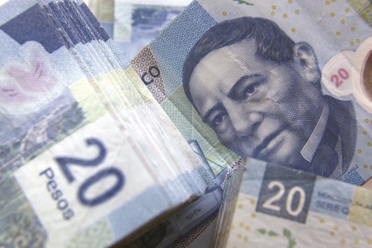 Mexican peso bills are seen in an arranged photograph in Mexico City. The peso has plummeted to record lows, and top analysts predict more pain.