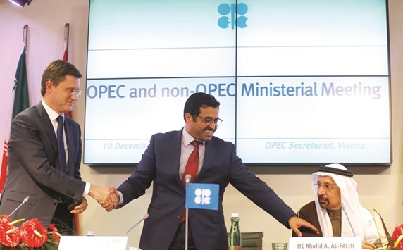 From left:  Russiau2019s Energy Minister Alexander Novak; Opec President and Qataru2019s Minister of Energy and Industry HE Dr Mohamed bin Saleh al-Sada and Saudi Arabiau2019s Energy Minister Khalid al-Falih shake hands after a news conference following a meeting at the Organisation of the Petroleum Exporting Countries headquarters in Vienna yesterday.
