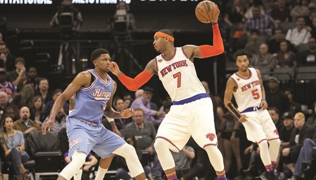 New York Knicks forward Carmelo Anthony (R) controls the ball against Sacramento Kings forward Rudy Gay.