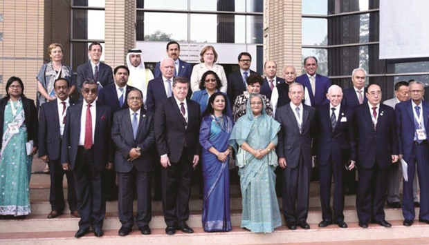 Prime Minister Sheikh Hasina with participants at the 9th Summit of the Global Forum on Migration and Development in Dhaka yesterday.