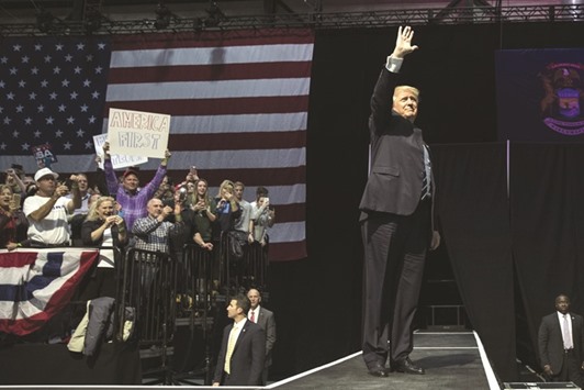 President-elect Donald Trump waves to the crowd as he arrives onstage at the DeltaPlex Arena in Grand Rapids, Michigan yesterday. Trump is continuing his victory tour across the country.