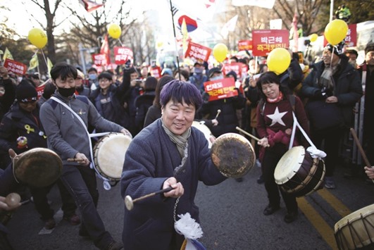 A traditional music band performs on the road leading to the Presidential Blue House during the protest against President Park.