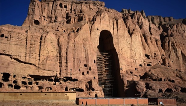 Afghan men at the site of the giant Buddha statues, which were destroyed by the Taliban