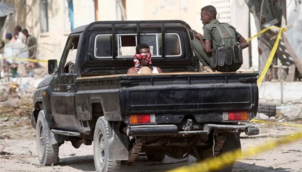 A security officer guards a suspected member of the al Shabaab in Mogadishu on Sunday.