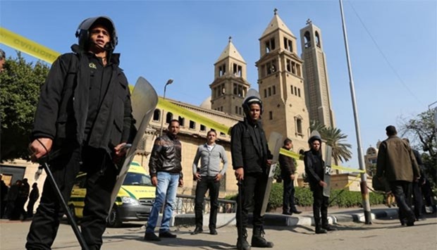 Members of the special police forces stand guard to secure the area around St. Mark's Coptic Cathedral after an explosion inside the cathedral in Cairo on Sunday.