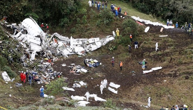 Rescue crew work at the wreckage of a plane that crashed into the Colombian jungle