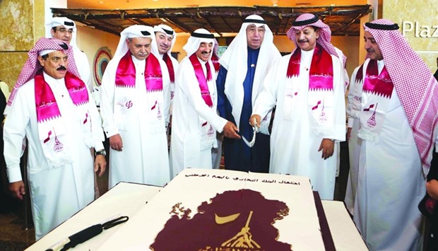 Commercial Bank board members led by Hussain Ibrahim Alfardan (third, right) and Omar Hussain Alfardan (fourth, left) marked the banku2019s Qatar National Day celebrations with cultural activities and a cake cutting ceremony at the Commercial Bank Plaza at West Bay. PICTURE: Jayaram