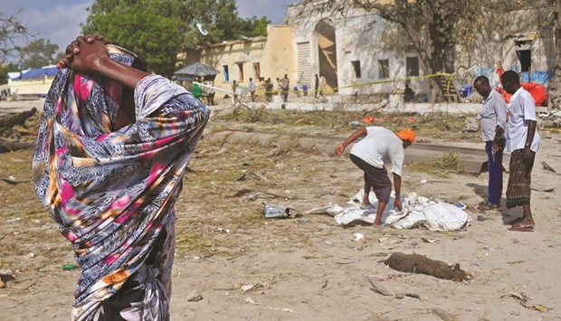 A woman wails at the site of the attack near the port of Mogadishu.