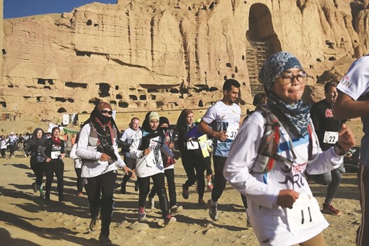 This file photo taken on November 4, 2016 shows Afghan and international runners taking part in a marathon on a course that took participants past the destroyed Buddha statues in Bamiyan province.