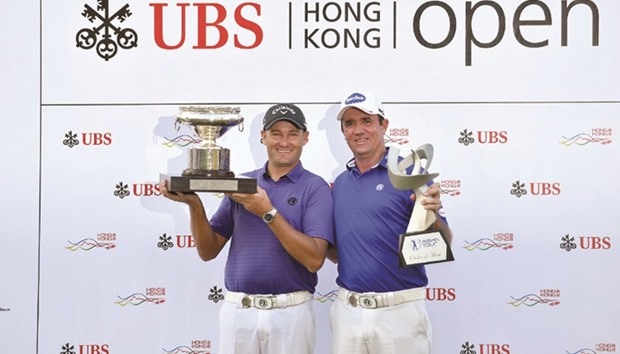 Sam Brazel of Australia (L) holding the winneru2019s trophy with Scott Hend of Australia holding the Asian Tour Order of Merit trophy after the final round of the UBS Hong Kong Open at the Hong Kong Golf Club. (AFP)