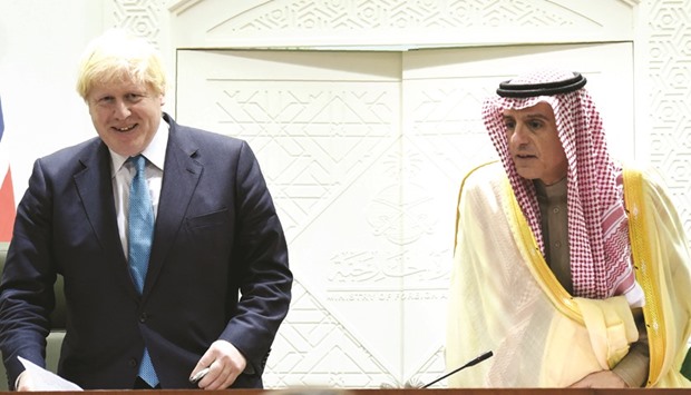 Saudi Minister of Foreign Affairs Adel al-Jubeir and British Foreign Secretary Boris Johnson arrive for a joint press conference in Riyadh yesterday.