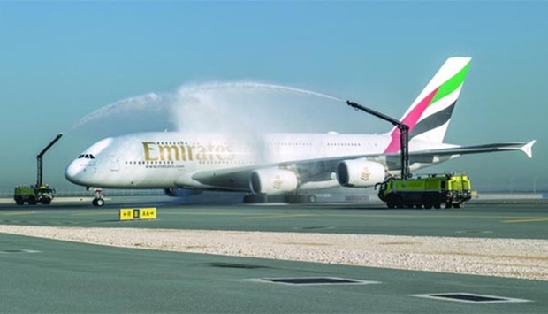 The Emirates A380 being greeted by a ceremonial water cannon salute at Hamad International Airport.