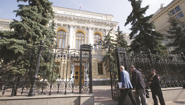 Visitors pass security to enter the headquarters of Russiau2019s central bank in Moscow. The Bank of Russia will leave its benchmark at 10% at a meeting on Friday, in line with a pledge made three months ago, according to 18 of 19 economists surveyed by Bloomberg.