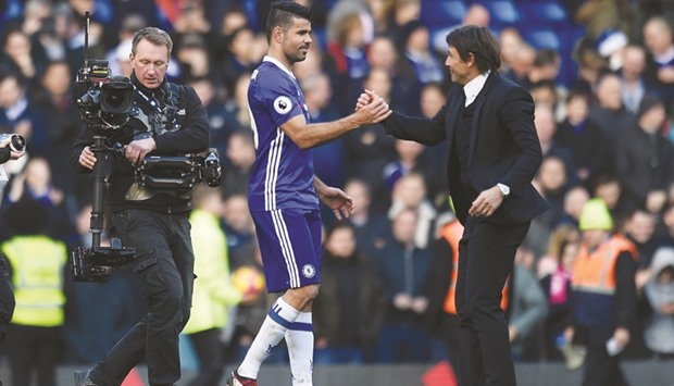 Chelsea manager Antonio Conte celebrates after the game with Diego Costa.