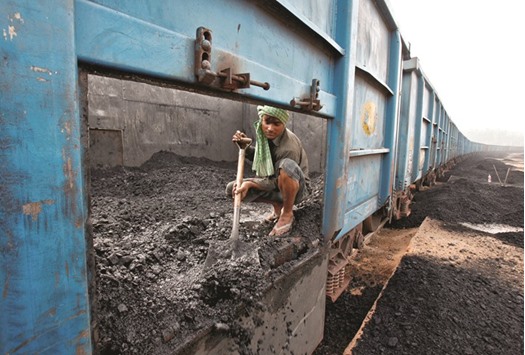 A worker unloads coal from a goods train at a railway yard in the northern city of Chandigarh, India. The government officials say Coal India, the worldu2019s largest coal miner, would be more competitive and efficient if it was divided into seven companies.